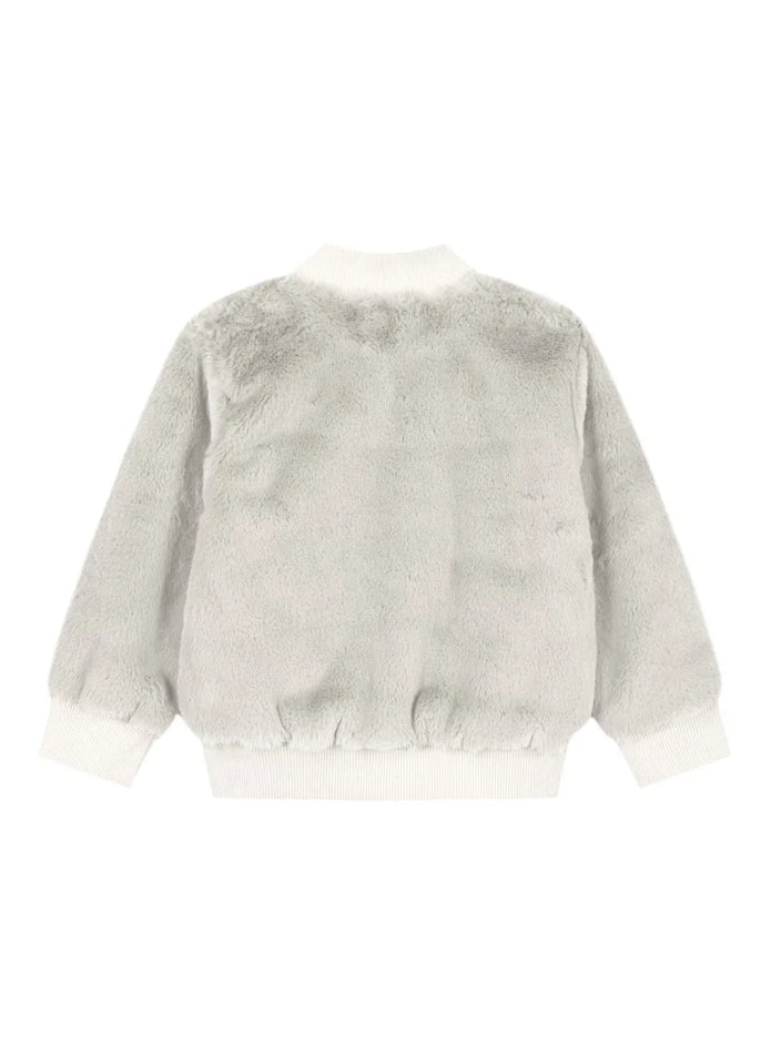 Παιδικό μπουφάν γούνας σε εκρού χρώμα, με φερμουάρ και ριπ λεπτομέρειες στη μέση και τα μανίκια, ιδανικό για ζεστές και κομψές χειμερινές εμφανίσεις για κορίτσι
