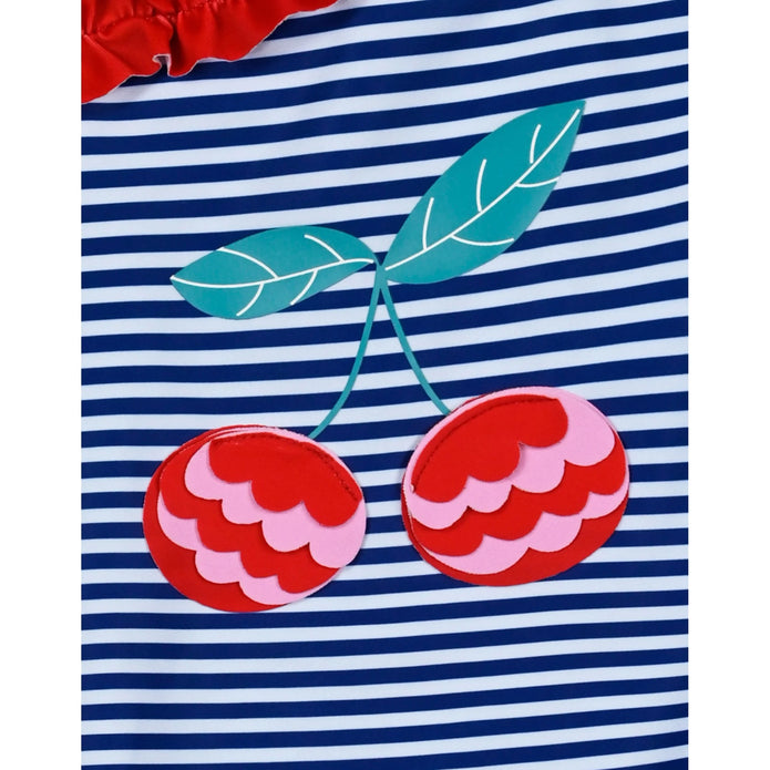 Παιδικό ολόσωμο μαγιό με μπλε-λευκές ρίγες, κόκκινα βολάν στον έναν ώμο και σχέδιο κεράσια. Μοντέρνα και παιχνιδιάρικη επιλογή για το καλοκαίρι.
